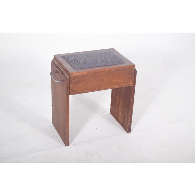Piano bench. with a simple, solid rectangular structure, it reflects a functional aesthetic characteristic of mid-20th...