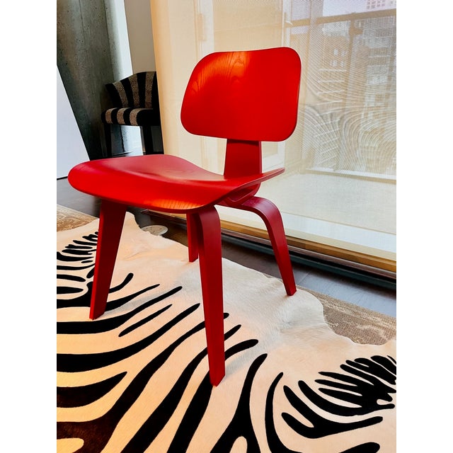 A set of 2 vintage Eames molded plywood dining chairs, designed by Charles & Ray Eames, 2006, pre-catalyzed lacquer...