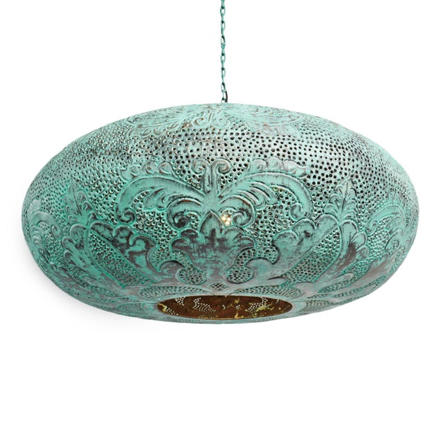 A sculptural statement in hand-worked copper, this Indonesian pendant is distinguished by its richly variegated verdigris...