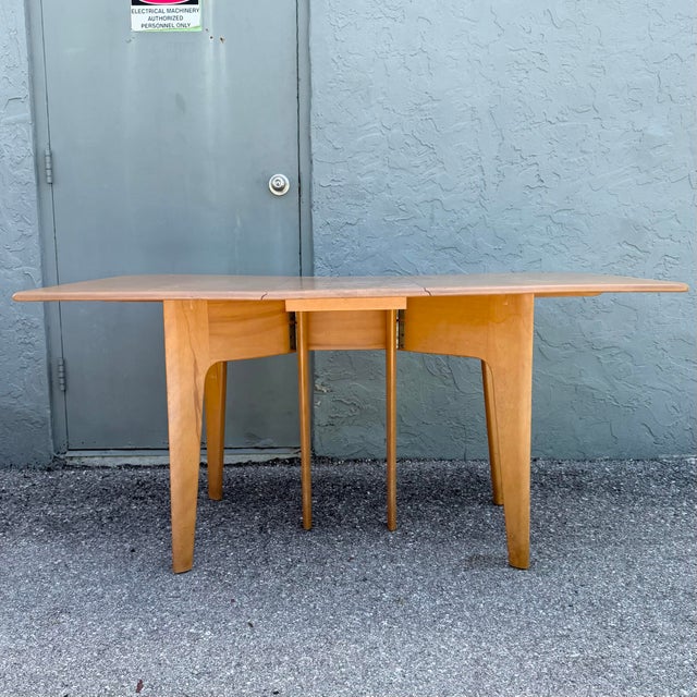 Center section with no leaves open measures 14 1/8 inches When closed measures: 15.75”w Classic Mid-Century Modern M166...