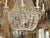 Early 19th century 3 tiers French crystal chandelier. Crystal bobeches. Iron arms are crystal beaded. The center shaft is...