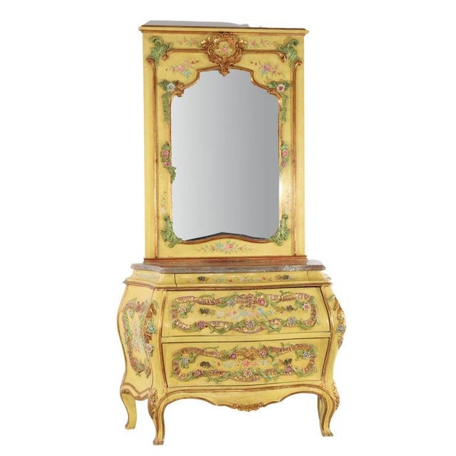 An exquisite antique Venetian polychromed dresser, circa 1930, featuring a distinguished trumeau mirror. This piece...