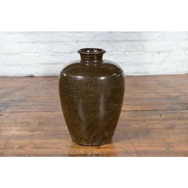 A large antique Thai storage jar from the early 20th century, with brown monochrome glazed finish and tapering lines....
