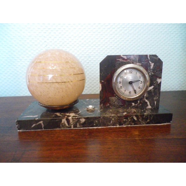 Table lamp with a marble-rimmed pendant light, mounted on a veined marble base, Art Deco style, with a salmon and white...