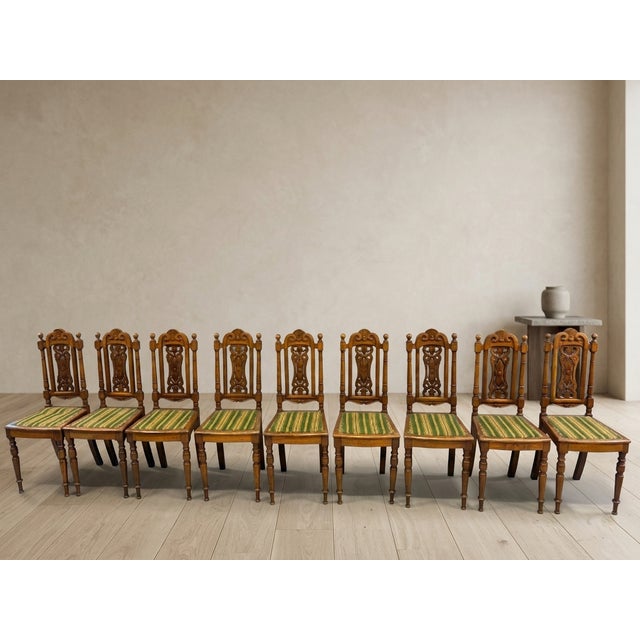 A set of 9 Renaissance Revival style dining chairs with tall backs and classic proportions. This is a set of dining chairs...