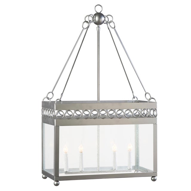 The ornamental rings on this lantern offer up a delicate design accent offering an inviting ambiance. Shown in a silver...