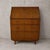 Details * Maker: Sutcliffe of Todmorden * Origin: United Kingdom * Era: 1960s * Material: Walnut veneer * Form: Fall-front...