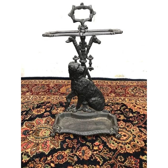 Antique Cast Iron Terrier Umbrella Stand. 19th century seated terrier cast dog with head turned and front paw raised...