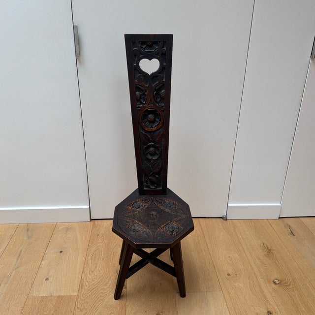 Antique spinning chair or peasant chair with fabulous hand carved details including the most charming heart cutout. Likely...