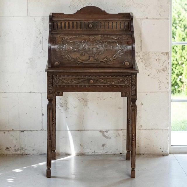 As beautiful as it is unusual, this 19th century French Louis XVI style cylinder cabinet was crafted from fruitwood and...