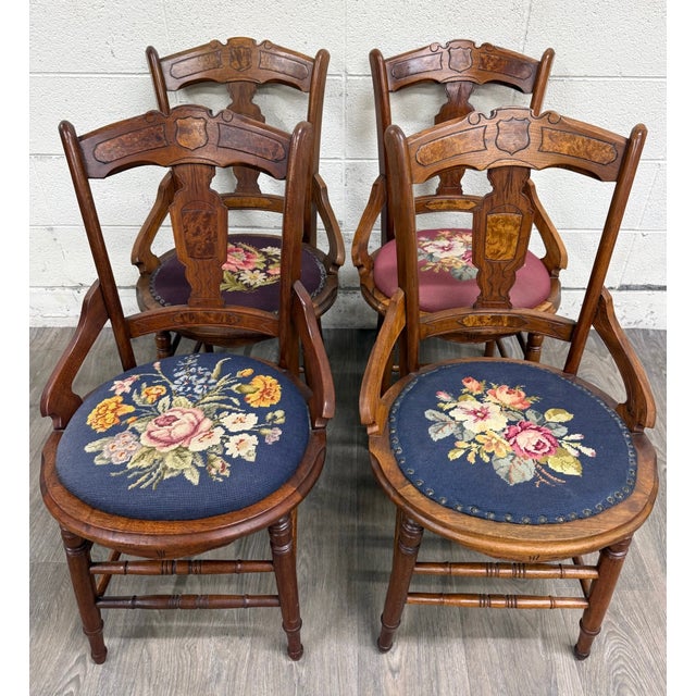 This is a gorgeous full set of four antique Victorian Eastlake-style walnut and needlepoint dining armchairs, circa late...