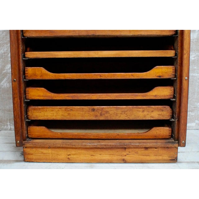 A superb oak tambour fronted plans chest. Made from oak, with a pull down tambour front, 12 pull out haberdashery type...