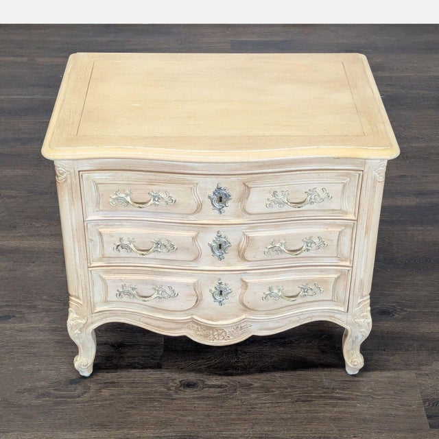 This Henredon nightstand features a classic French Provincial design with three spacious drawers for convenient storage....