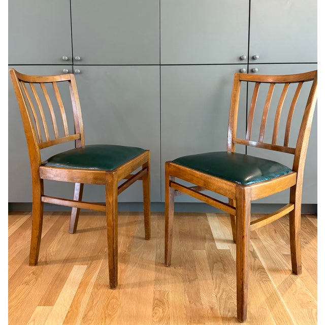 Pair of vintage mid century solid wood (oak?) chairs with hunter green leather or faux leather upholstered seats....