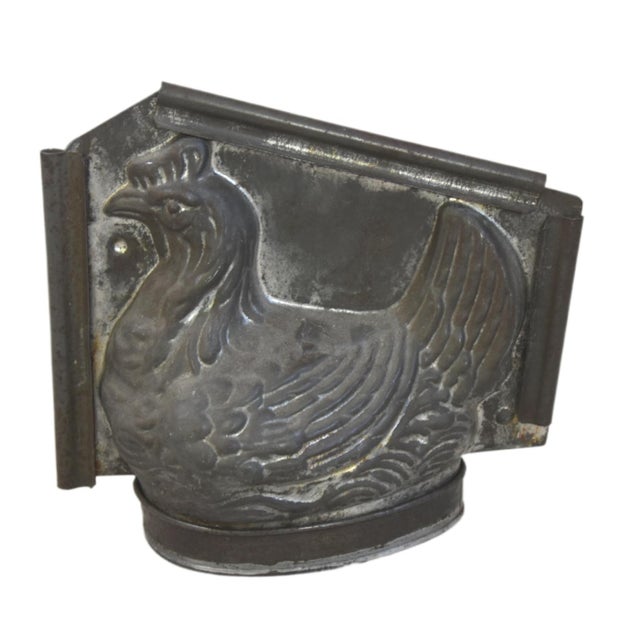 An antique tin-plated metal chocolate or ice cream mold shaped like a nesting hen. These highly collectible, two-part...