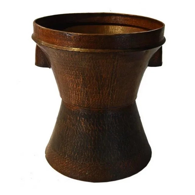 This mid-20th century grain basket was made in India with hand-hammered copper. The basket adopts an hourglass shape...