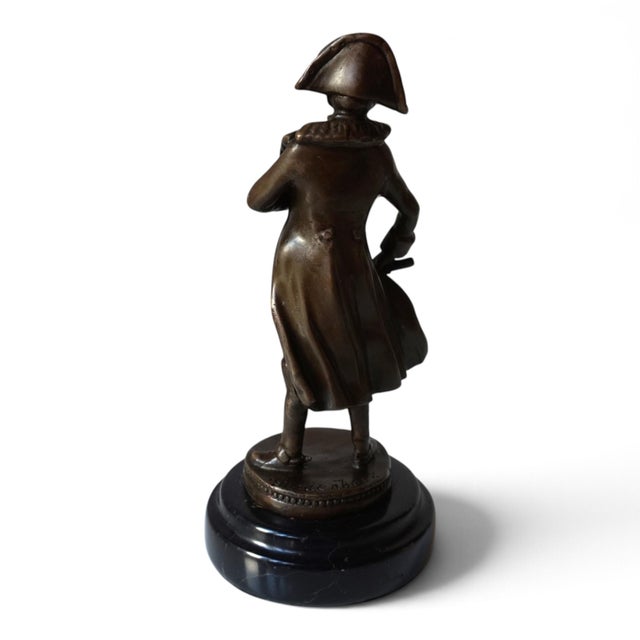 This expressive bronze sculpture depicts Napoleon Bonaparte in his characteristic military pose. with his famous bicorn...