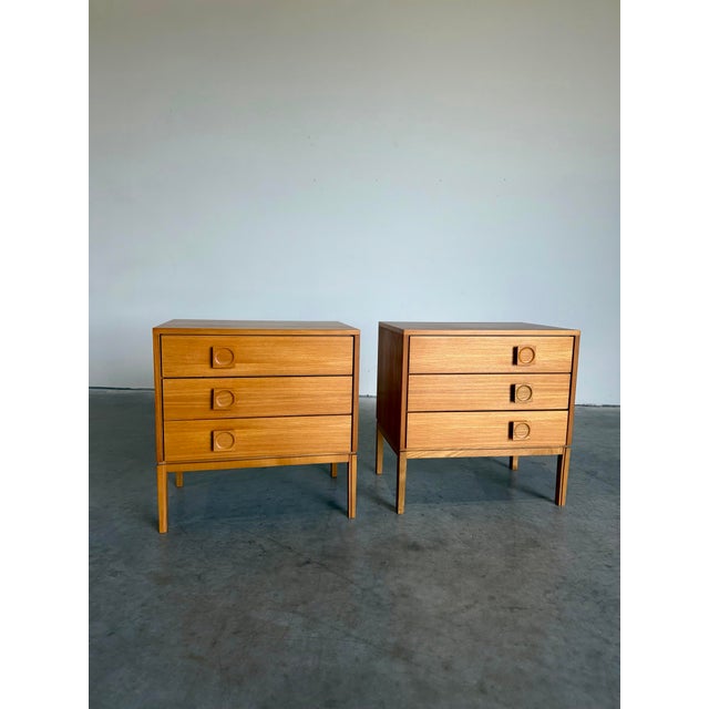 Set of two blonde wood 3 drawer chests, perfect as nightstands or end tables. Light blonde wood with offset square pulls...