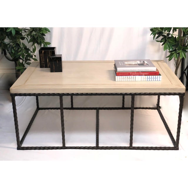 This handsome coffee table features a hammered iron base in bronze with a hand painted 1.5 " wood top in a cream strie...