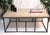 This handsome coffee table features a hammered iron base in bronze with a hand painted 1.5 " wood top in a cream strie...