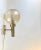 Lounge Sconce with Spherical Amber colored glass shade with controlled bubbles. It was manufactured and designed by...