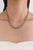 This vintage-style tennis necklace showcases 9.88 carats of natural oval emeralds, set in 14K yellow gold,each measuring...