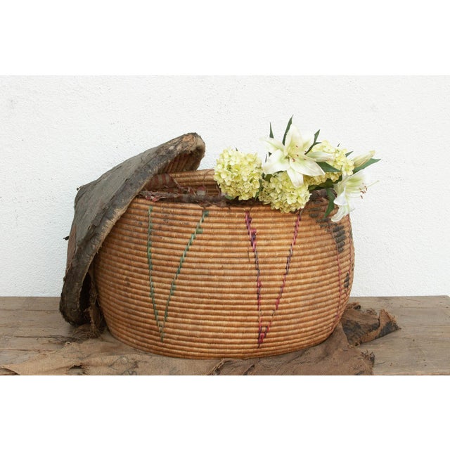 Standing nearly two and a half feet tall, this monumental storage drum is a rare and powerful example of nomadic utility....