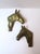 A detailed pair of brass-plated metal horse heads or busts wall art sculptures, Equestrian aesthetic, circa mid-20th...