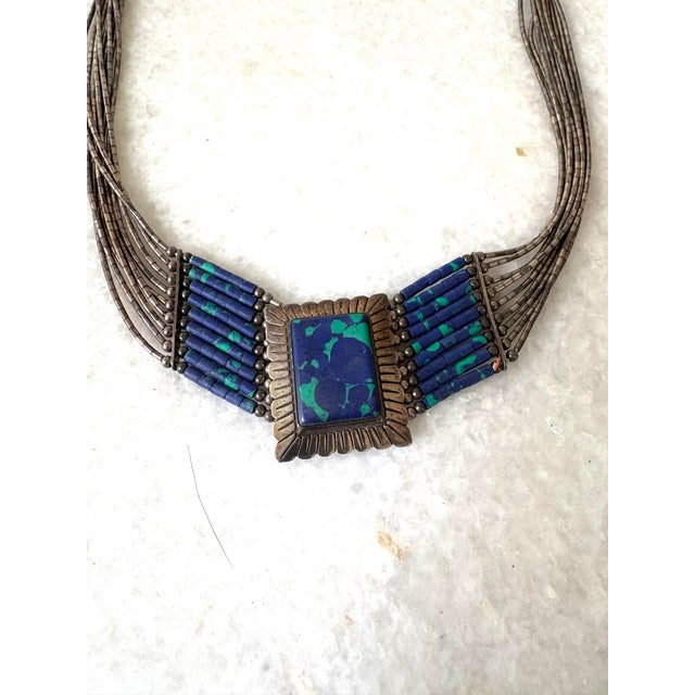 Native American multi-strand liquid silver necklace features an azurite-malachite center pendant