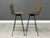 A set of four mid century modern iron frame bar stools in the style of Arthur Umanoff. Two seats swivel and two seats are...