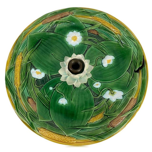 Minton Majolica centerpiece, naturalistically modeled as a pond bed with simulated water glazed in cyan blue, with green...