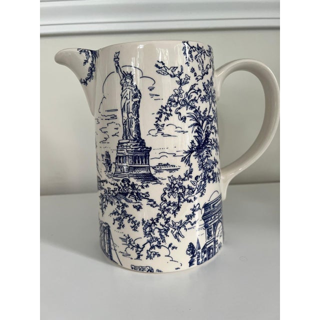 This elegant signed Tiffany & Co. ceramic pitcher features a classic blue and white transferware toile pattern celebrating...