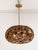 Striking sculptural pendant light featuring a brass framework inset with circular amber and smoke-toned glass lenses. The...