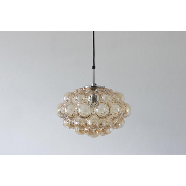 The Bubble pendant lamp, designed by Helena Tynell and manufactured by the German company Limburg in the 1960s. This model...