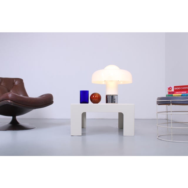 A striking 60 × 60 cm square Space Age coffee table dating from the 1970s. Its sculptural, chunky 18mm thick legs, softly...