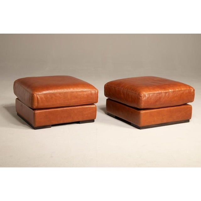 Baxter leather poufs, original and still bearing the brand name. The leather is in perfect condition, with a few minor...