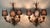 A pair of midcentury Venetian tole wall sconces, each with three lights each and decorated with gilded leaves. The candles...