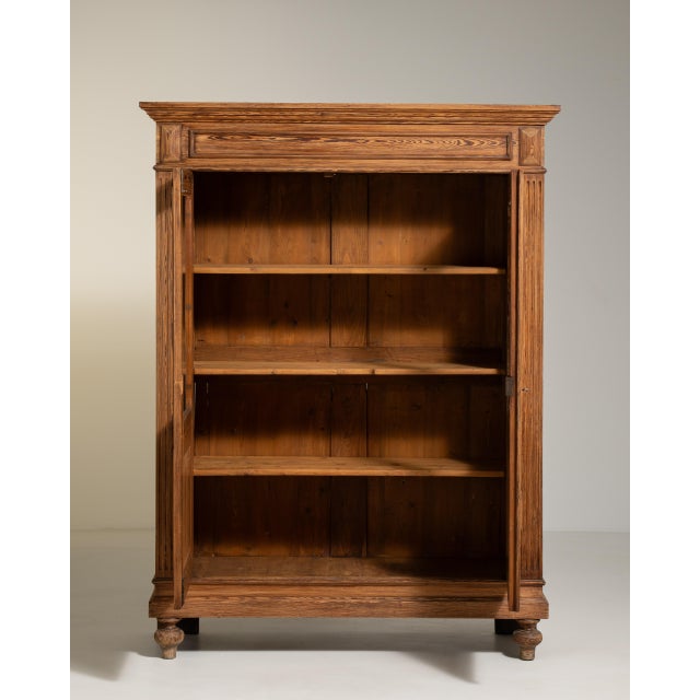A classic oak display cabinet combining simple lines with functional storage and display space. The natural wood grain and...