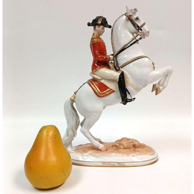 Porcelain figurine of a Lipizzaner horse, rider from the Spanish Riding School, performing the "Courbette" move; Figure is...