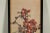 This delicate Japanese painting on paper captures a bright yellow bird perched among flowering branches in full bloom....