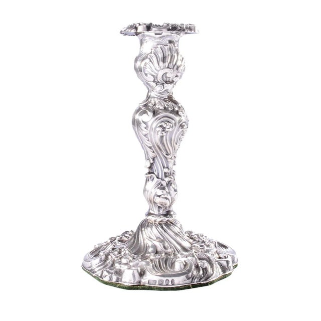 Antique English set of four George IV sterling candlesticks in a repousse rococo pattern of shells, scrolls, leaves and...