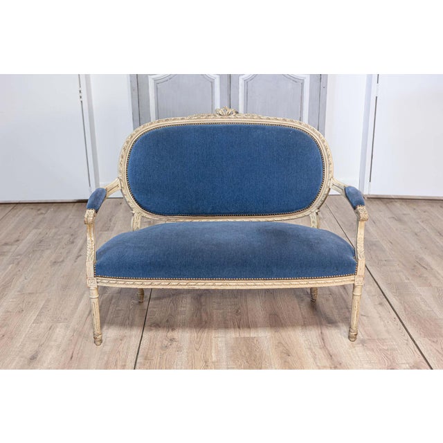 This elegant late 19th-century Louis XVI-style sofa is crafted from beech wood, painted in a soft antique finish that...
