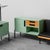 Credenza with 2 -seater sofa produced in the 1960s. Sage green wood structure. Metal details. Black skii sofa coating. It...
