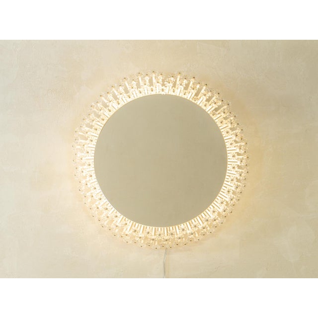 Wonderful "Space Age" mirror from the 1960s with transparent acrylic flowers on white steel slats. The mirror has new LED...