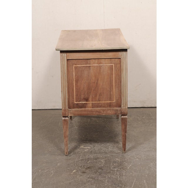 An Italian wood raised chest of two drawers from the 19th century. This antique cassettiera (chest of drawers) from Italy...