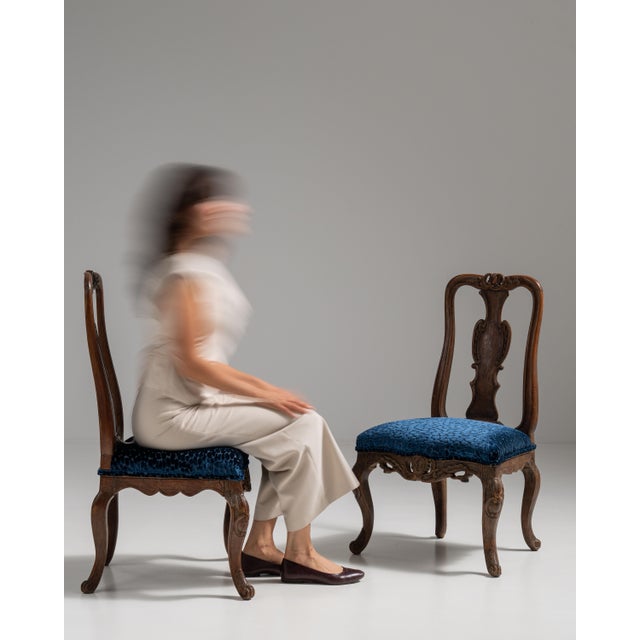 This pair of 19th century Louis XV oak chairs with upholstered seats from France, made in dark oak with pierced, vase-...