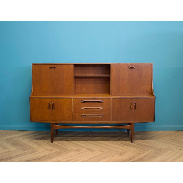 A teak highboard from the G Plan Fresco range, dating to the late 1960s / early 1970s. Standing on tapered legs, the piece...