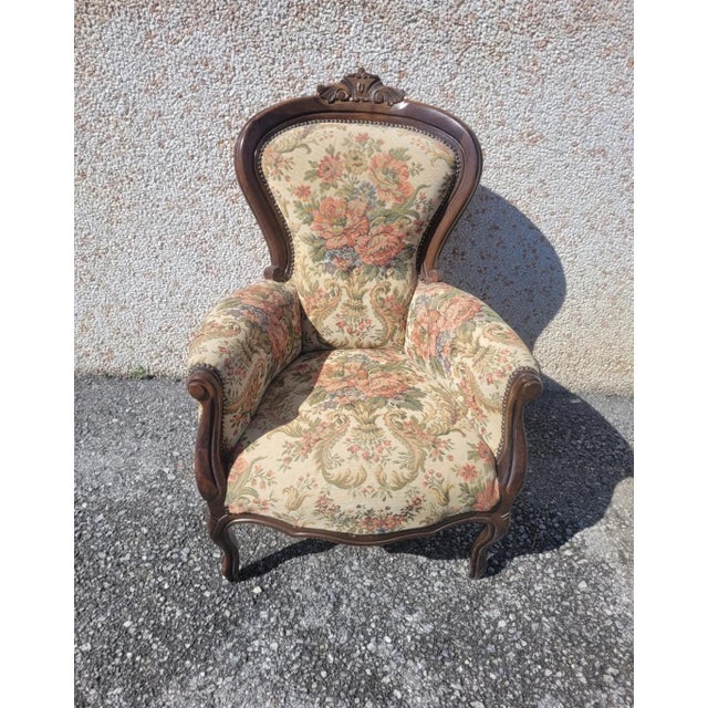Antique armchair in solid walnut, Louis Philippe style with floral padding.