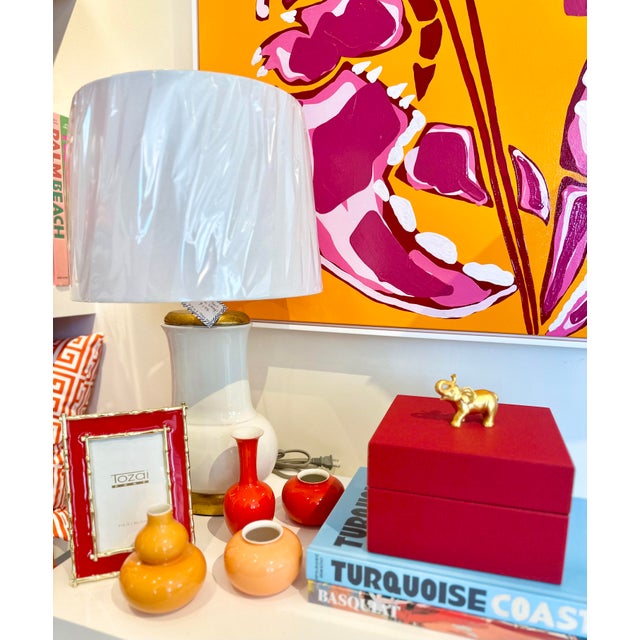 Felt lined wooden box covered in faux red leather with a metallic gold elephant on top. By Chelsea House. Overall...