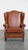 Offered is this stylish and in correct condition cognac colored cowhide leather English style ear chair with decorative...